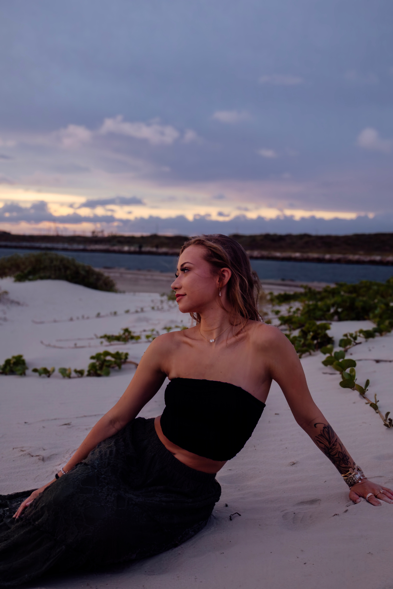 Senior seated on the beach at dusk