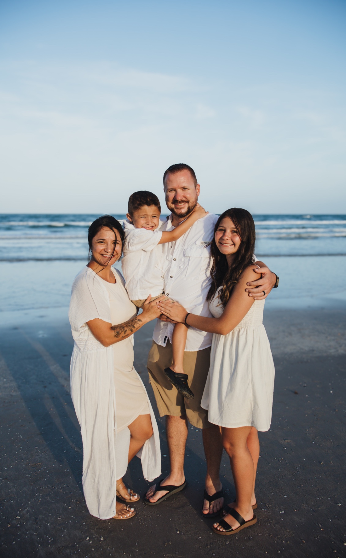 Family portrait on the beach at sunset