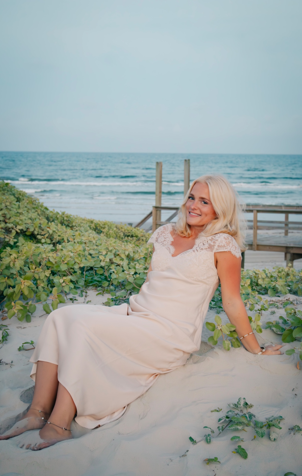 Senior in cream dress on the dunes